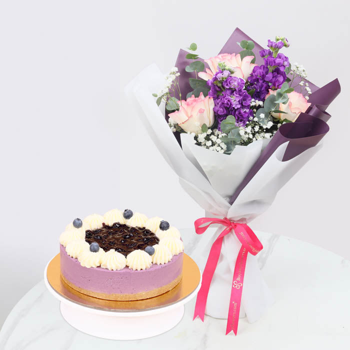 Lavender GraceChocolate & Confectionery6 Pink Roses 5 Stems of Purple Stock or Lisianthus 3 Stems of Baby’s Breath (Gypsophila) Fresh Eucalyptus Greens Beautifully wrapped in dual-tone white and purple paper and tied with a satin ribbon. 4 Portion Tiramis