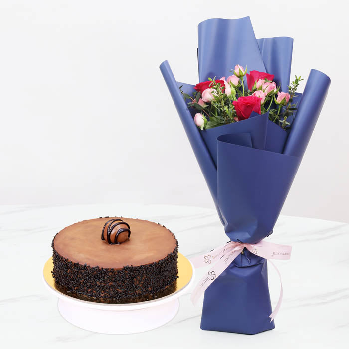 Rose IndulgenceChocolate & Confectionery3 Dark Pink Roses 2 Stems of Pink Baby Roses 1 Stem of Parvifolia Elegantly wrapped in violet-colored paper and tied with a soft pink ribbon. 4 Portion Truffle Cake
