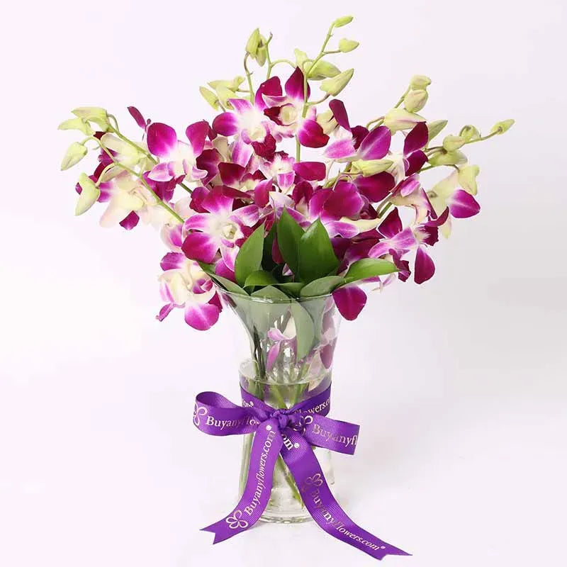 10 purple orchids arranged in vase