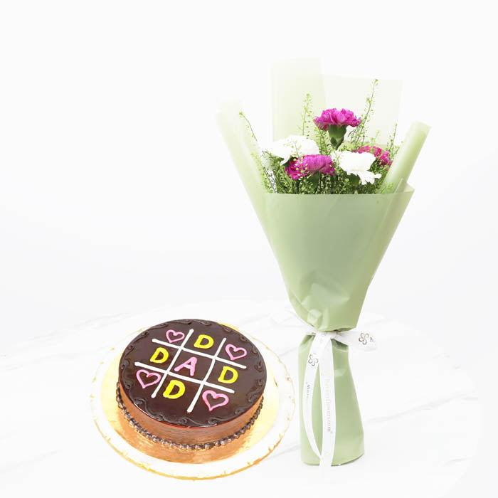 Dad Tender LoveChocolate & Confectionery4 Portion Love for Dad Cake 3 Purple Carnations 2 White Carnations 2 Lepidium Stems Wrapped in green paper and tied with a white ribbon.