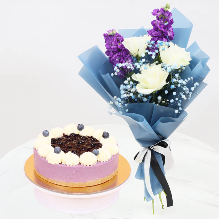 Midnight EleganceChocolate & Confectionery2 Matthiola Stems 3 White Roses 2 Stems of Baby’s Breath (Gypsophila) Beautifully wrapped in navy blue paper and tied with a black and white ribbon. 4 Portion Blueberry Cheesecake