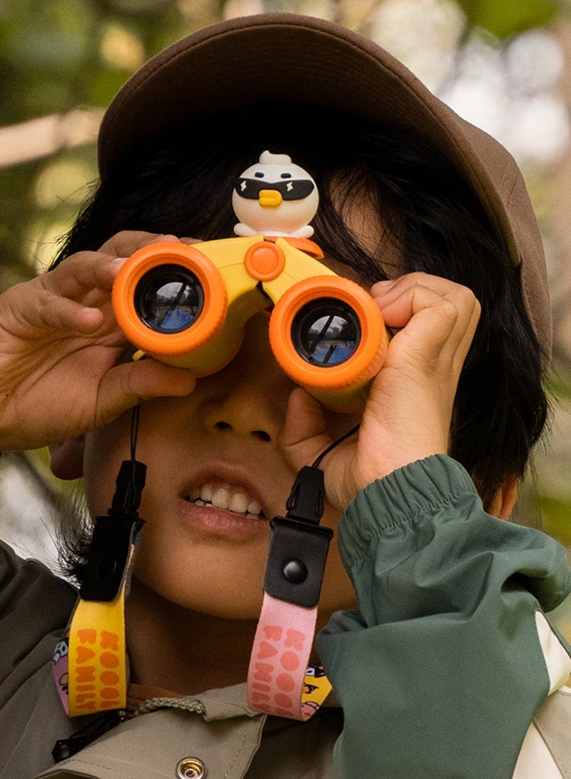 Child with binoculars and a penguin-themed attachment, outdoors