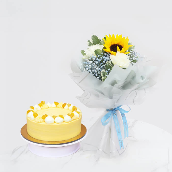 Sun-Kissed BlissChocolate & Confectionery1 Bright Yellow Sunflower 3 Elegant White Roses 2 Stems of Soft Blue Baby’s Breath (Gypsophila) Fresh Greenery for a Natural Touch Beautifully wrapped in translucent white paper and tied with a soft blue satin ribb