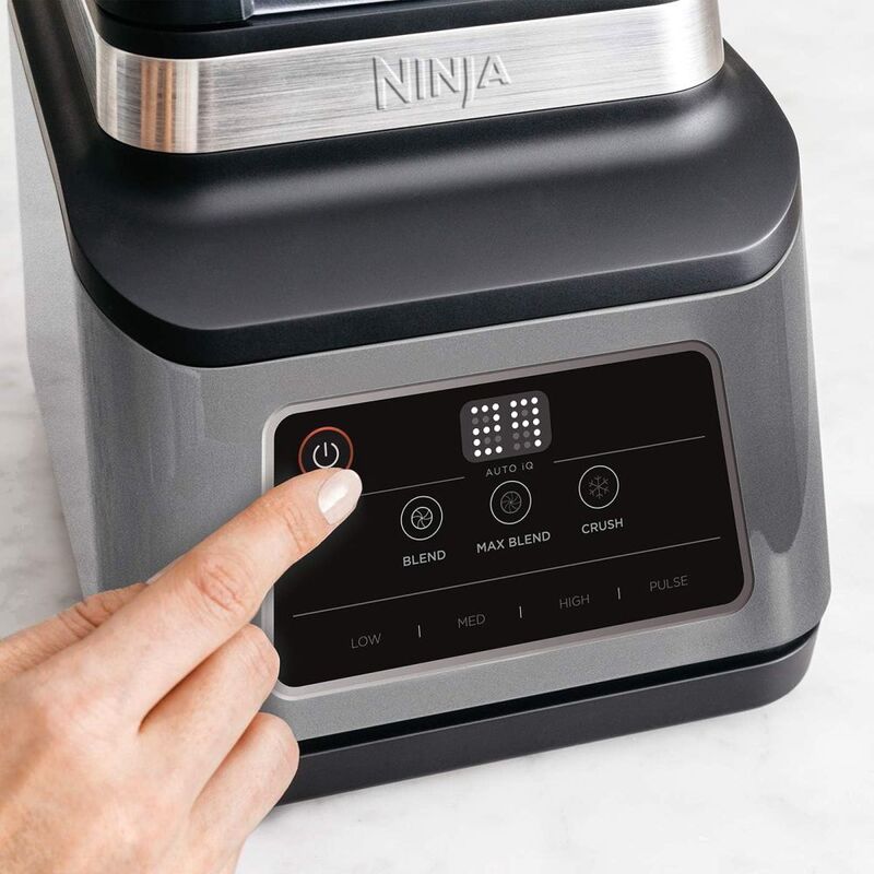Ninja BN750 blending smoothie in personal and large cup