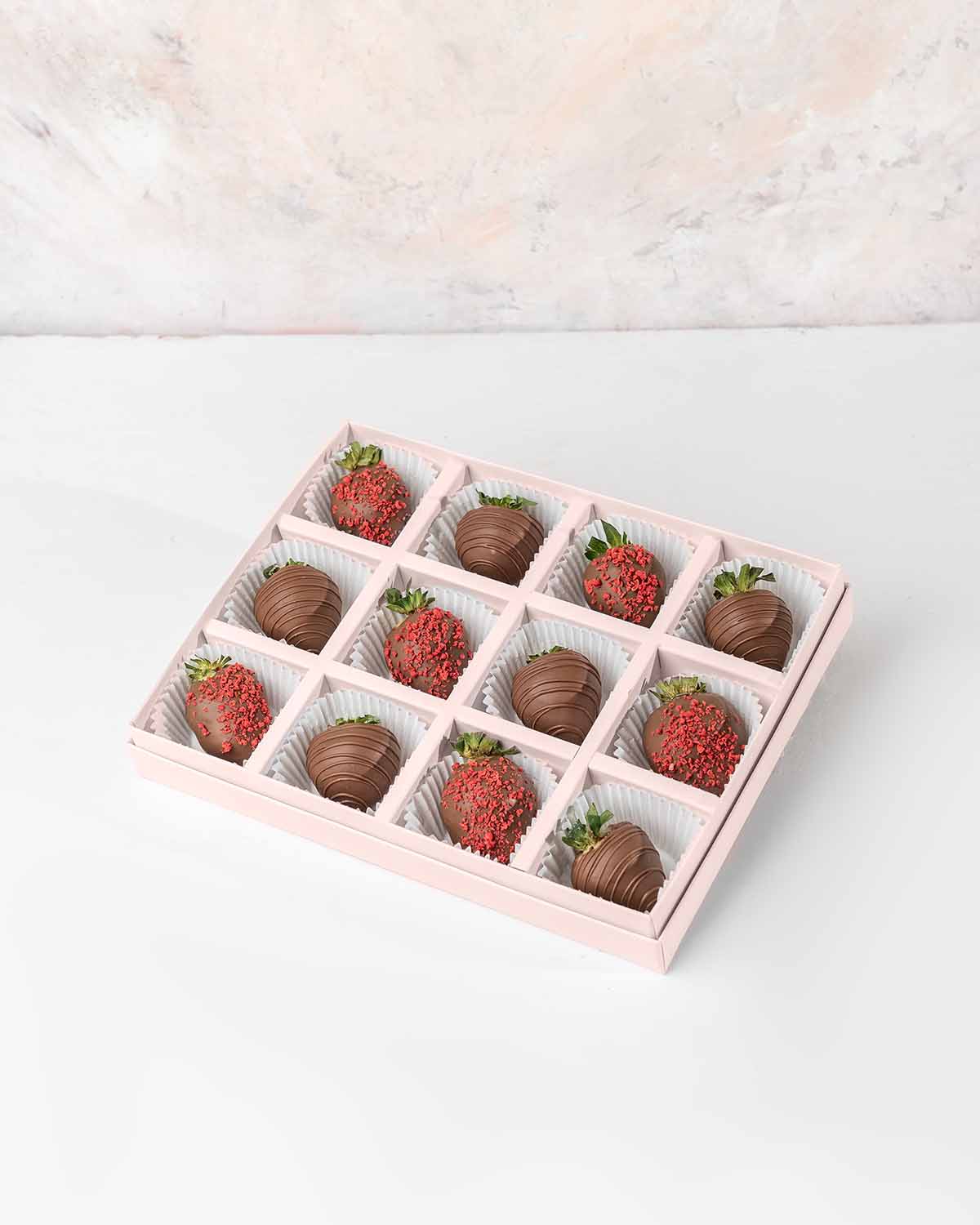 Milk Chocolate Strawberries '24 Collection by NJDChocolate & ConfectioneryYour Gift Contains:• 12 x Chocolate covered strawberries• Box Size: 24x18x4cmHandling and Storage • Keep away from direct heat and sunlight• Best stored between 12-18 °C• Strawberri
