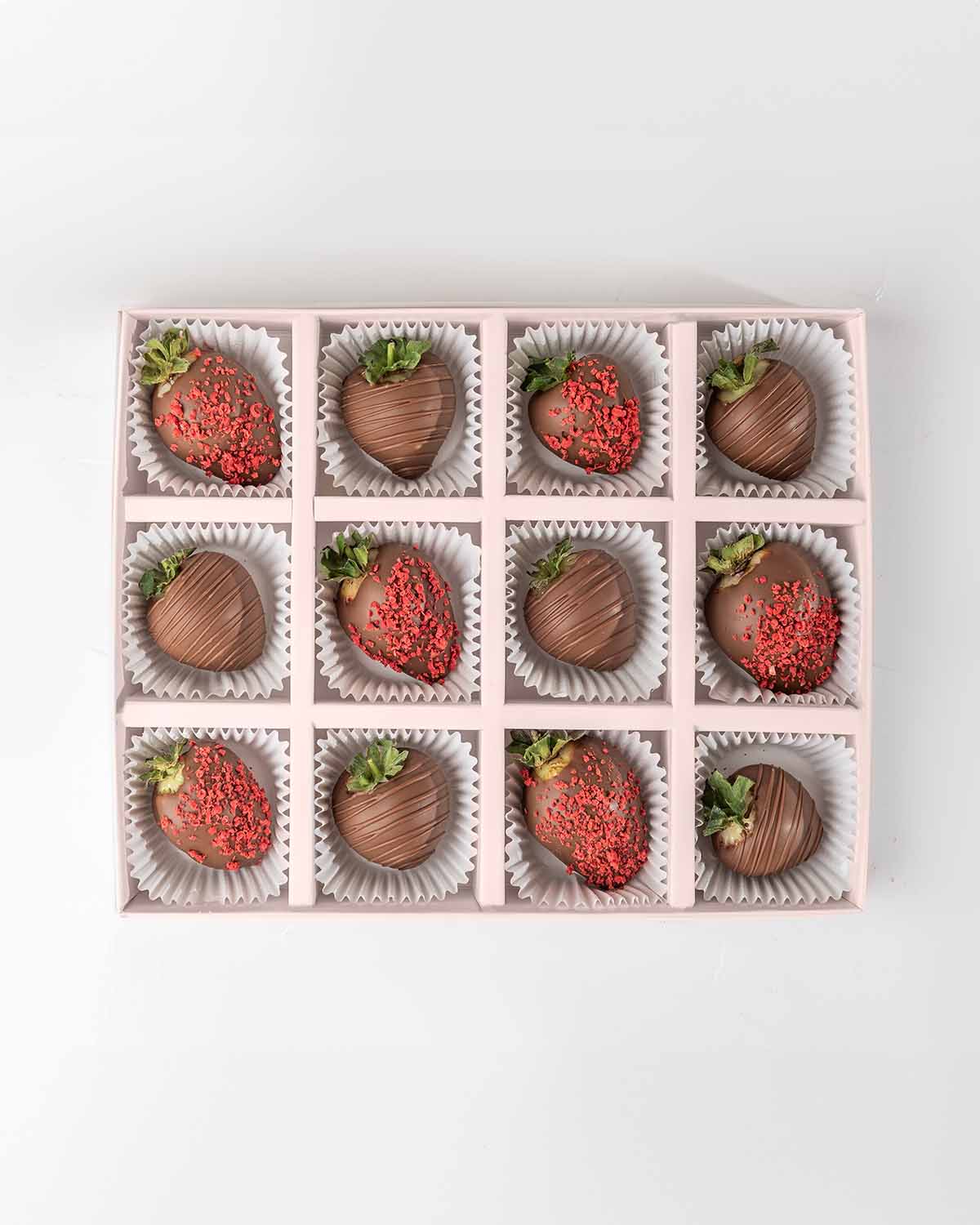 Milk Chocolate Strawberries '24 Collection by NJDChocolate & ConfectioneryYour Gift Contains:• 12 x Chocolate covered strawberries• Box Size: 24x18x4cmHandling and Storage • Keep away from direct heat and sunlight• Best stored between 12-18 °C• Strawberri