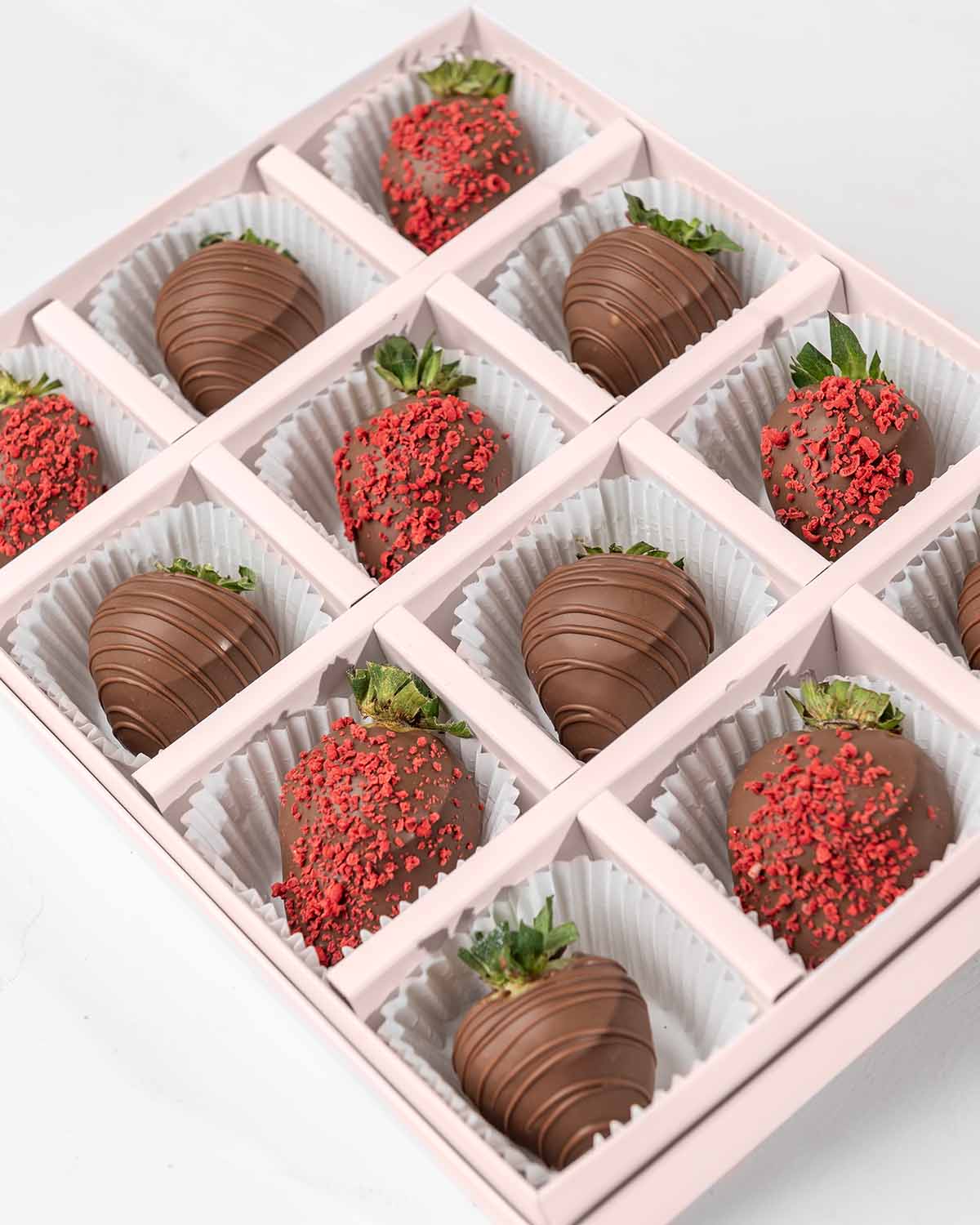 Milk Chocolate Strawberries '24 Collection by NJDChocolate & ConfectioneryYour Gift Contains:• 12 x Chocolate covered strawberries• Box Size: 24x18x4cmHandling and Storage • Keep away from direct heat and sunlight• Best stored between 12-18 °C• Strawberri