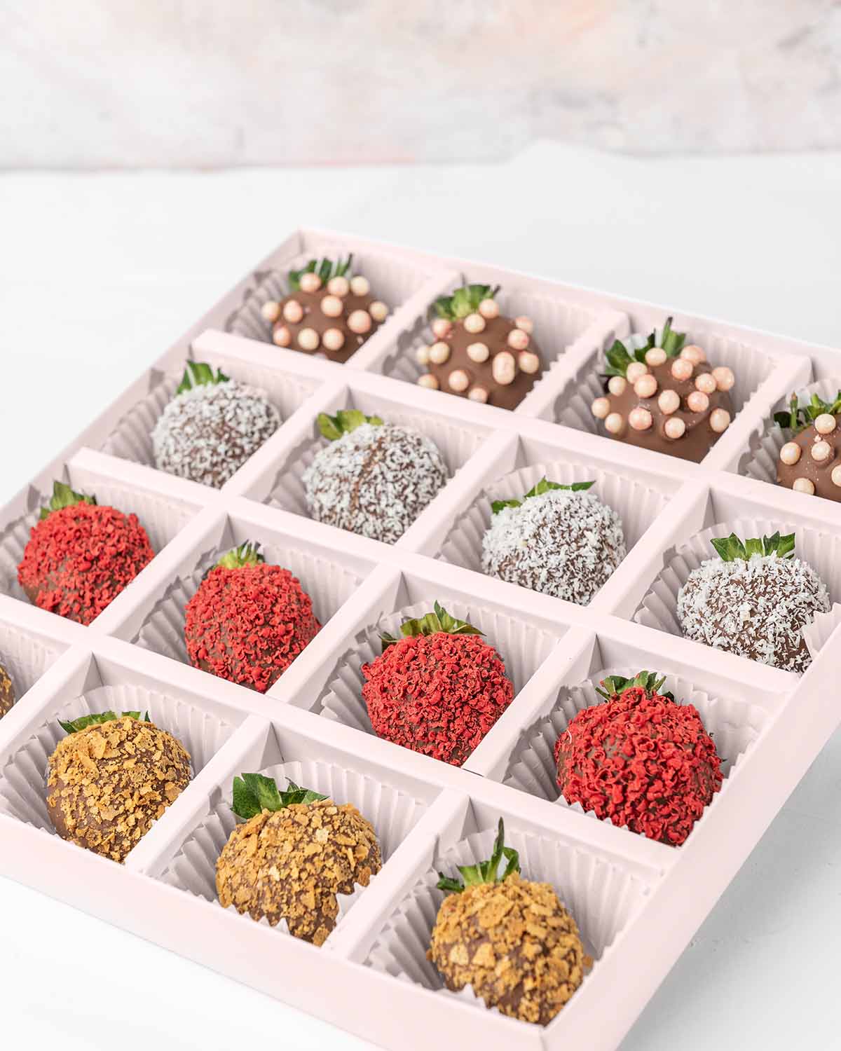 16 Chocolate Strawberries '24 Collection by NJDChocolate & ConfectioneryYour Gift Contains:• 16 x Chocolate covered strawberries• Box Size: 24x24x4cmHandling and Storage • Keep away from direct heat and sunlight• Best stored between 12-18 °C• Strawberries
