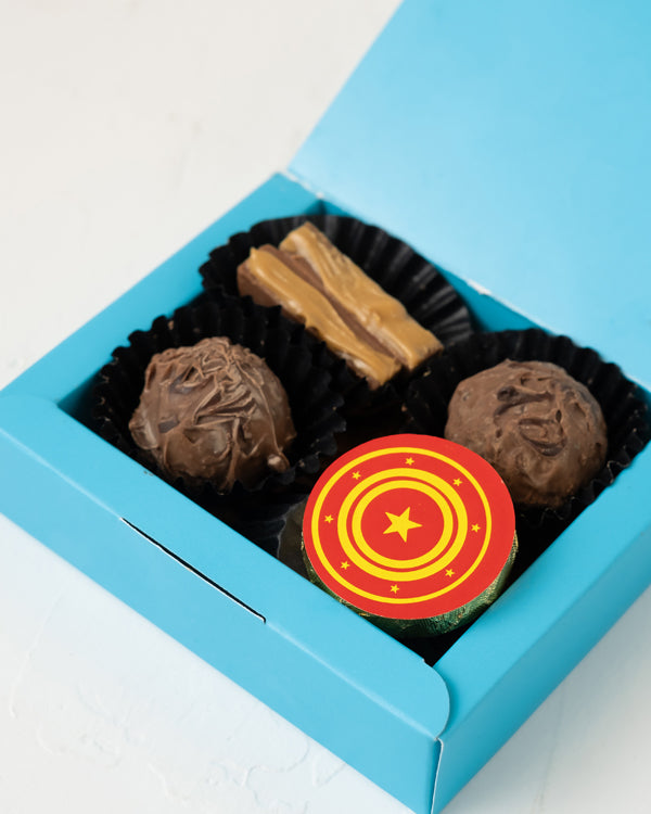 Truffles and CrackersChocolate & ConfectioneryYour Gift Contains: • 4 Assorted Milk Chocolate • Flavors: Speculoos and Hazelnut • Weigh of chocolate: 56grams • Box Size: 10x8x3cm Handling and Storage • Keep away from direct heat and sunlight • Best stored
