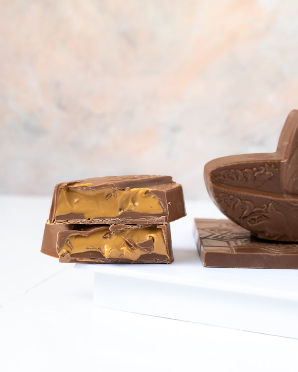 Chocolate Edible Diya by NJDChocolate & ConfectioneryYour Gift Contains: • 1 Belgian Milk Chocolate Diya Bar • Weigh of chocolate: 160grams • Size of Chocolate: 10x10x7.5cm • Box Size 16.5x16.5x20cm Handling and Storage • Keep away from direct heat and su