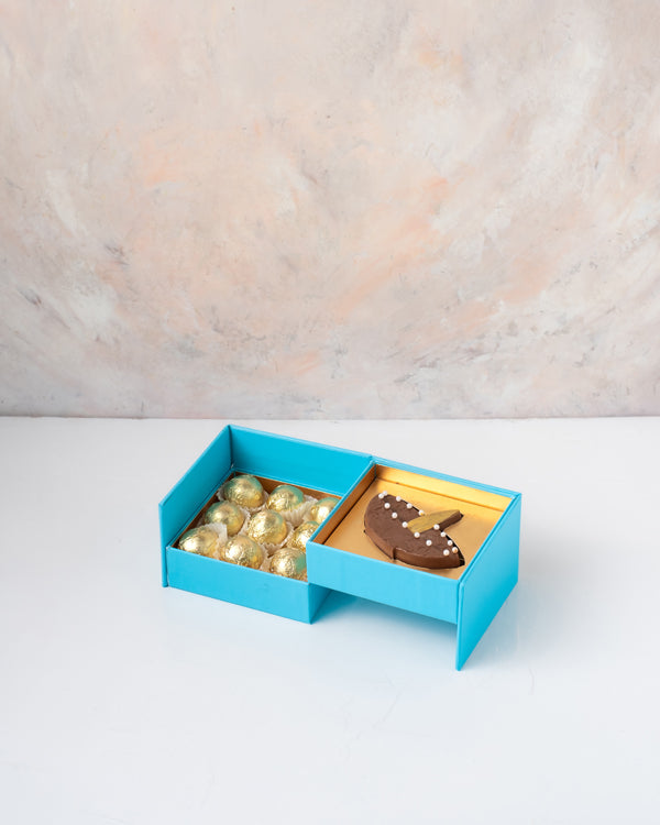 Diya and Golden Truffles by NJDChocolate & ConfectioneryYour Gift Contains: • 1 Milk chocolate Diya Bar • 9 assorted Milk chocolate Truffles • Weigh of chocolate: 250grams approx. • Flavors: Pistachio, Hazelnut, Speculoos, Peanut Butter and Roche • Box Si