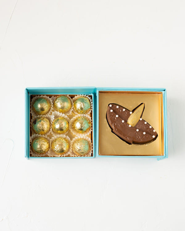 Diya and Golden Truffles by NJDChocolate & ConfectioneryYour Gift Contains: • 1 Milk chocolate Diya Bar • 9 assorted Milk chocolate Truffles • Weigh of chocolate: 250grams approx. • Flavors: Pistachio, Hazelnut, Speculoos, Peanut Butter and Roche • Box Si