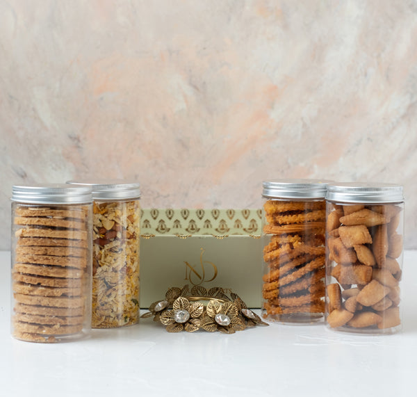 Savory Aaliyah CollectionChocolate & ConfectioneryYour Gift Contains: • 1 designer Diya • 200grams Shankarapali • 110grams Mukrumm • Butter Cookies • 150grams Diet Savory • Box Size: 28x24x8cm • Design of Diya may vary Handling and Storage • Keep away fro