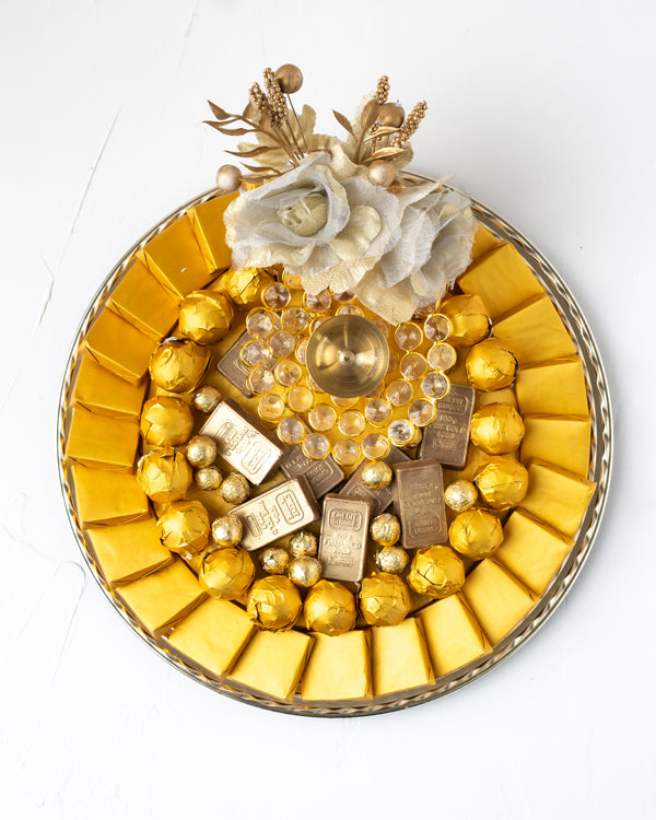 Golden Diwali HamperChocolate & ConfectioneryYour Gift Contains: • 1 designer Diya • 25 assorted Milk Chocolates • 20 assorted Milk Chocolate Truffles • 8 mini golden Milk chocolate bars • 170g of Wheat Crispies chocolate Dragee • Weigh of chocolate: 950g