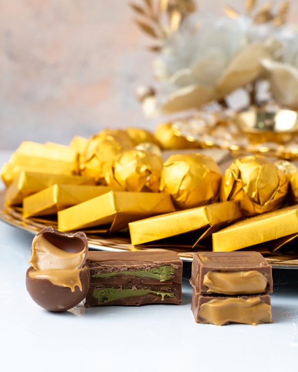 Golden Diwali HamperChocolate & ConfectioneryYour Gift Contains: • 1 designer Diya • 25 assorted Milk Chocolates • 20 assorted Milk Chocolate Truffles • 8 mini golden Milk chocolate bars • 170g of Wheat Crispies chocolate Dragee • Weigh of chocolate: 950g