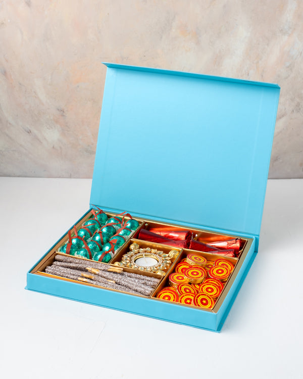Edible Fire Crackers and Diya Collection by NJDChocolate & ConfectioneryYour Gift Contains: • 1 designer Diya • 6 Mini chocolate cones • 20 Sparkler theme chocolate stick • 15 assorted Milk chocolate truffles • 20 Milk chocolate coins • Weigh of chocolate