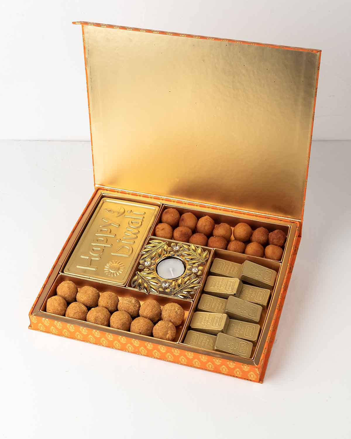 Ladoo and Chocolate Diwali Gift BoxChocolate & ConfectioneryYour Gift Contains:• 1 x Diya • 1 x Happy Diwali Chocolate Bar• 10 x Edible gold bullion chocolate filled in Pistachio, Kunafa, Hazelnut, Speculoos, Peanut Butter and Roche (more flavors availabl