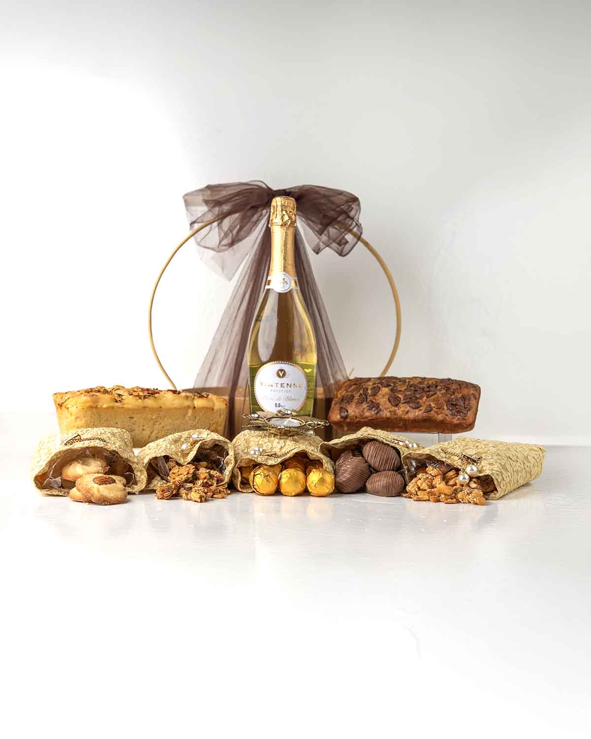 Diwali Luxury HamperChocolate & ConfectioneryYour Gift Contains:• 1 Diya• 300gm Chocolate Covered Dates• 1 Non Alcoholic Wine• 300gm Caramelized Cashew• 250gm Homemade Granola• 200g Butter Cookies• 384g Milk Chocolate Truffles Filled in Pistachio, Hazelnu