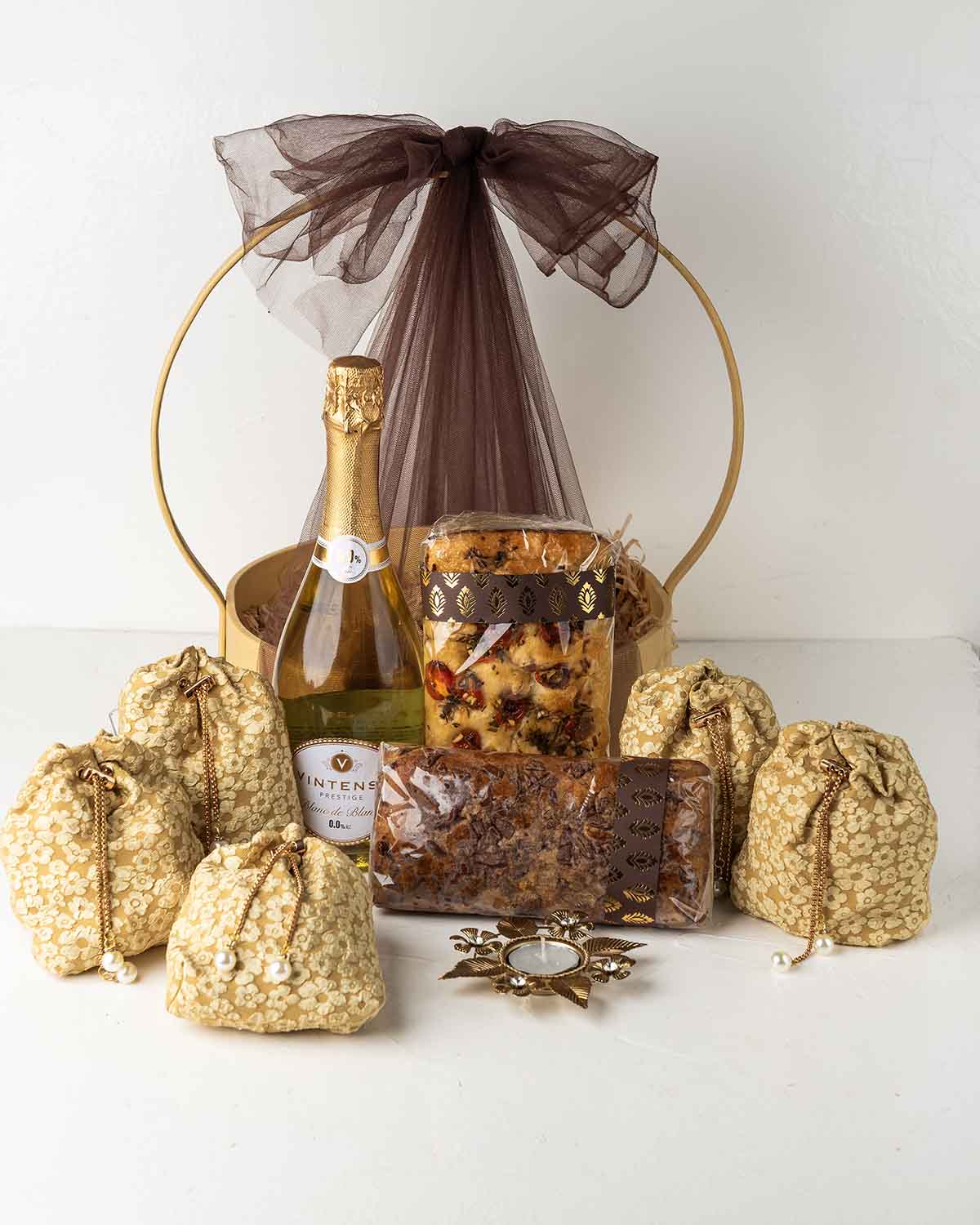 Diwali Luxury HamperChocolate & ConfectioneryYour Gift Contains:• 1 Diya• 300gm Chocolate Covered Dates• 1 Non Alcoholic Wine• 300gm Caramelized Cashew• 250gm Homemade Granola• 200g Butter Cookies• 384g Milk Chocolate Truffles Filled in Pistachio, Hazelnu