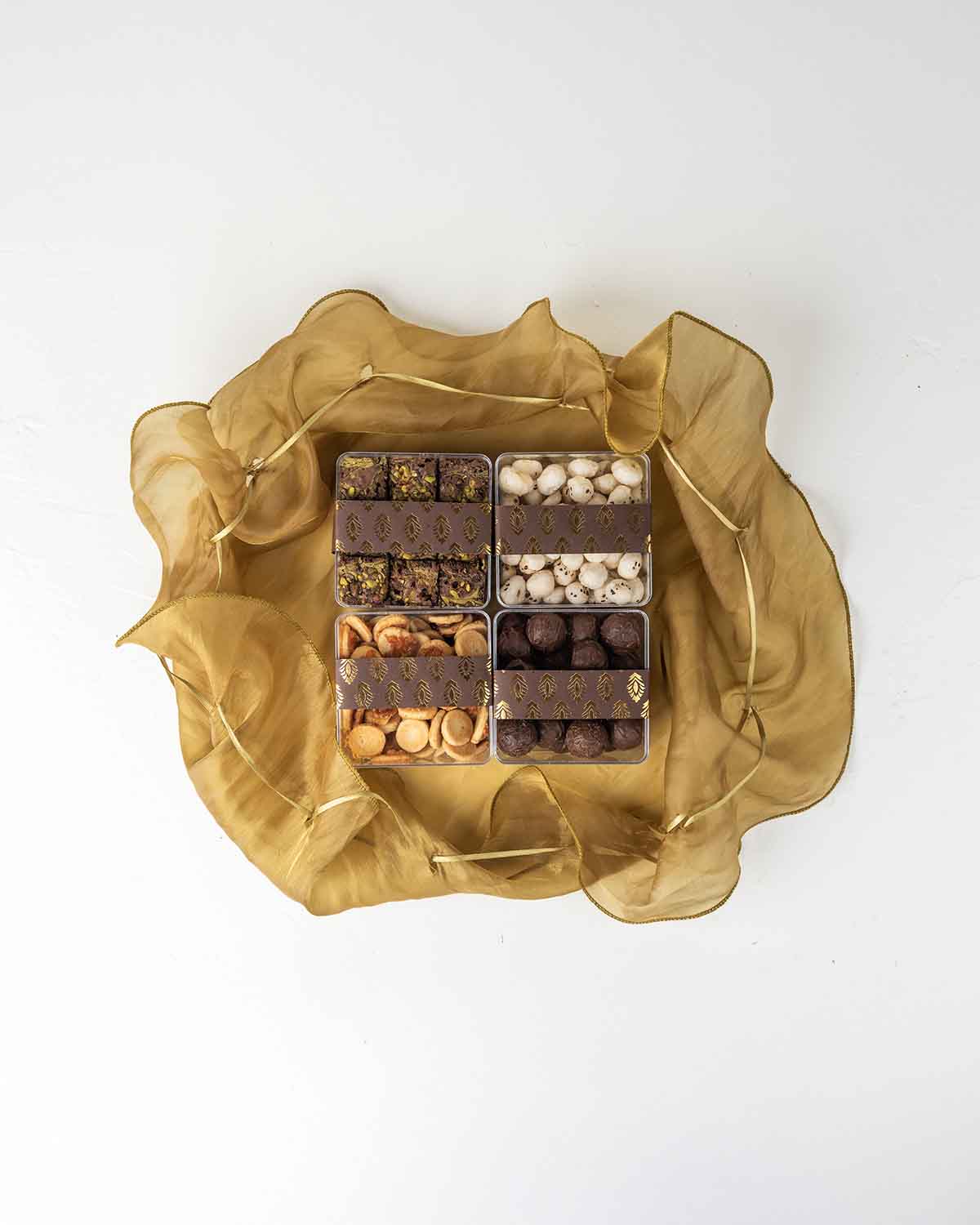 Diwali Assortment with Savory and SweetsChocolate & ConfectioneryYour Gift Contains:• 150gm Savory Chilly Biscuit• 350gm Brownie Bites • 30gm Savory Fox Nut• 300gm Milk Chocolate Truffles filled in Pistachio, Hazelnut, Speculoos, Peanut Butter and Roche•