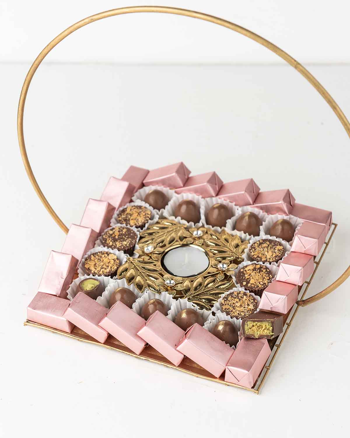 Chocolate Tray by NJDChocolate & ConfectioneryYour Gift Contains:• 1 Diya• 6 Milk Chocolate Topped with Biscoff• 10 milk chocolate truffles• 20 Assorted Milk chocolates• Flavors: Pistachio, Hazelnut, Speculoos, Peanut Butter and Roche (more flavors availa