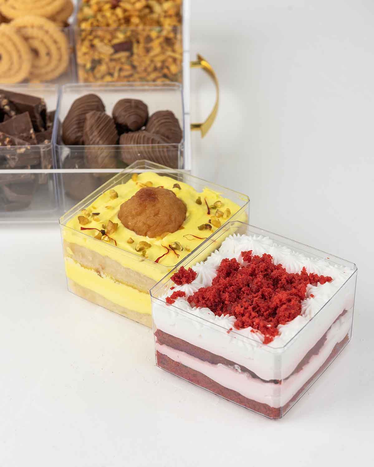Multiple Assortment Diwali Gift TrayChocolate & ConfectioneryYour Gift Contains:• 200gm Chirwa Flakes• 30gm Savory Fox Nuts• 150g Murukku • 120g Savory Chilly Biscuit• 300gms Brownie Cake• 200gms Vanilla Cake with Strawberry• 200gms Gulab Jamun flavor cak