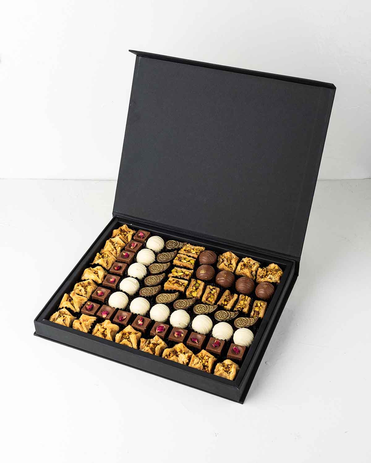 Truffles, Baklawa and Bonbon Gift BoxChocolate & ConfectioneryYour Gift Contains:• 17 x Bookaj Pistachio• 9 x Assieh Pistachio• 25 x Assorted Milk Chocolates• 11 x White Chocolate Truffles• Flavors: Pistachio, Hazelnut, Speculoos, Peanut Butter and Roche