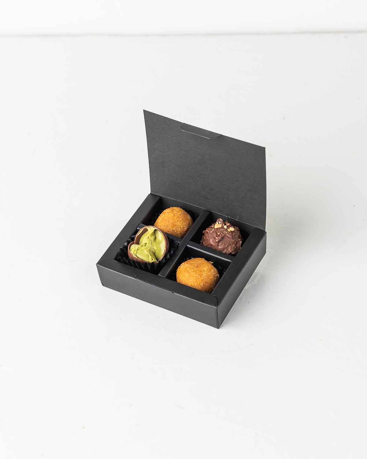 Mini Diwali TreatChocolate & ConfectioneryYour Gift Contains:• 2 x Besan Laddu• 2 x Milk Chocolate Truffles • Box Size: 10x8x2.5cmHandling and Storage • Keep away from direct heat and sunlight• Best stored between 12-18 °C• Suitable for vegetarians • Not