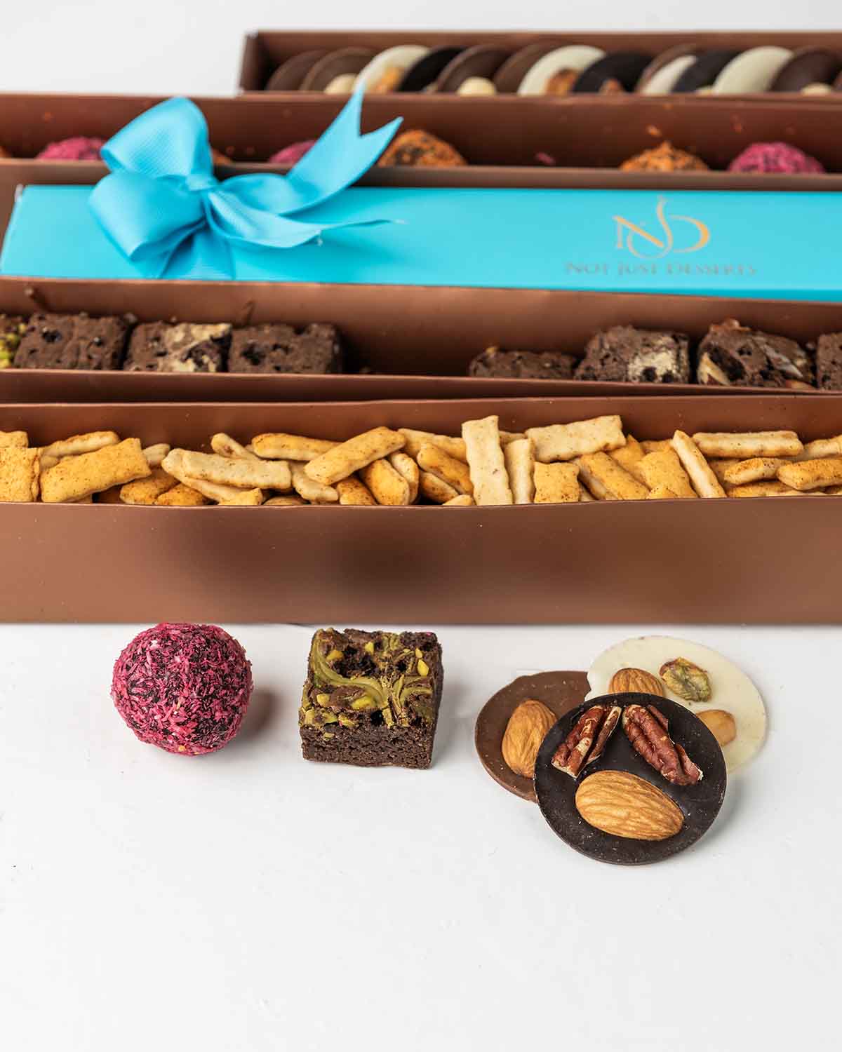 Limited Edition Diwali'24 CollectionChocolate & ConfectioneryYour Gift Contains:• 10 x Assorted French Truffles• 155g Savory Chilly Biscuit • (25pcs)120g White, Milk and Dark Chocolate Coins with Nuts• 250gm (12) Brownie Bites• Box Size: 35x4x4cmHandling