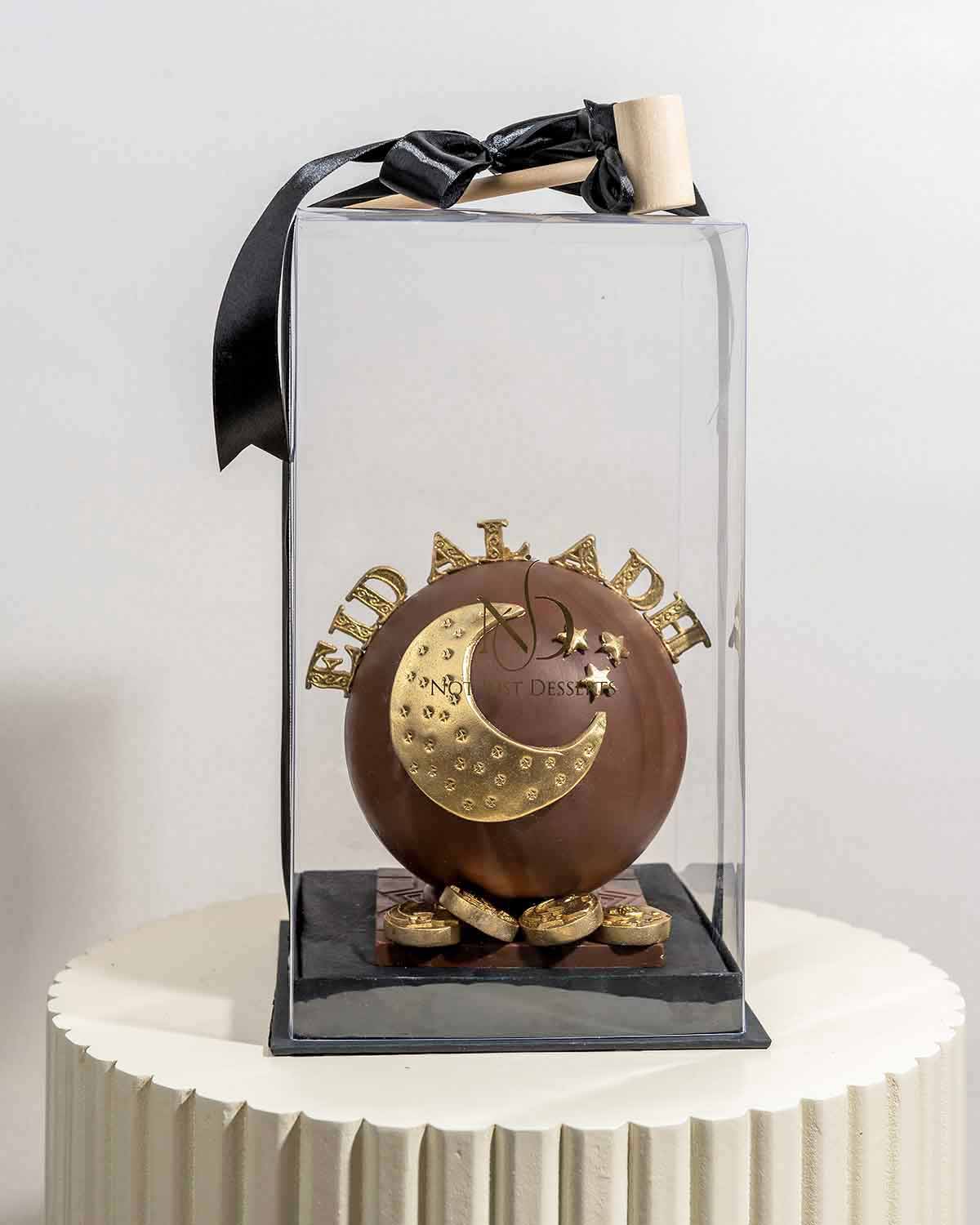 EID Al ADHA SMASH BallChocolate & ConfectioneryYour Gift Contains:• Approx 560g Eid al Adha Smash Ball• 10pcs Milk Chocolate Assorted Truffles • Flavors: Pistachio, Hazelnut, Speculoos, Peanut Butter and Roche • Chocolate size: 12x12x15cm • 1x Hammer• Cho