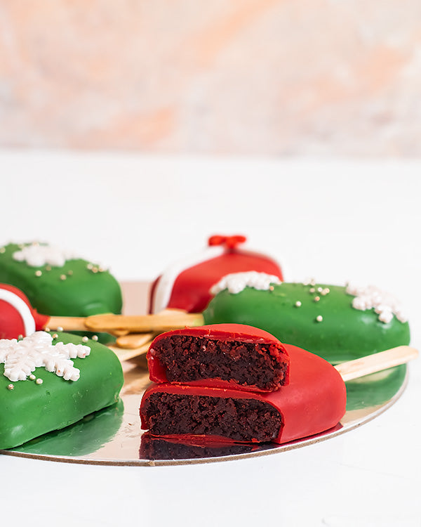 Christmas CakesiclesChocolate & ConfectioneryYour Gift Contains: • 6 pieces Christmas theme Red Velvet and Chocolate flavor cakesicles • Box Size: 18x18x23.5cm Handling and Storage • Keep away from direct heat and sunlight • Best stored between 12-18 °C •