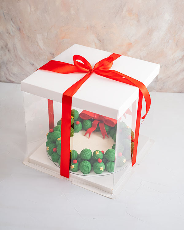 Truffles and Cake pops WreathChocolate & ConfectioneryYour Gift Contains: • Wreath made with 58 Cake pops and Assorted Truffles • Truffles flavors: Pistachio, Hazelnut, Peanut Butter, Sepculoos, Roche, Kinder and Rice Krispies • Cake pop Flavors: Red Velv