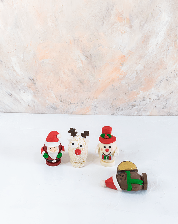 Edible Christmas Characters by NJDChocolate & ConfectioneryYour Gift Contains: • Christmas characters made with assorted Milk and White chocolate • 4 pieces - 125 grams each • Flavor: Hazelnut, Peanut Butter, Roche and Kinder • Weight of Chocolate: 500gra