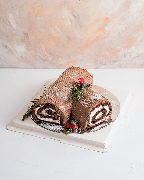 Yule log Cake by NJDChocolate & ConfectioneryYour Gift Contains: • 1kg classic chocolate cake with light creamy filling • Box Size: 20x20x30cm Handling and Storage • Keep away from direct heat and sunlight • Best stored between 12-18 °C • NOT Suitable for