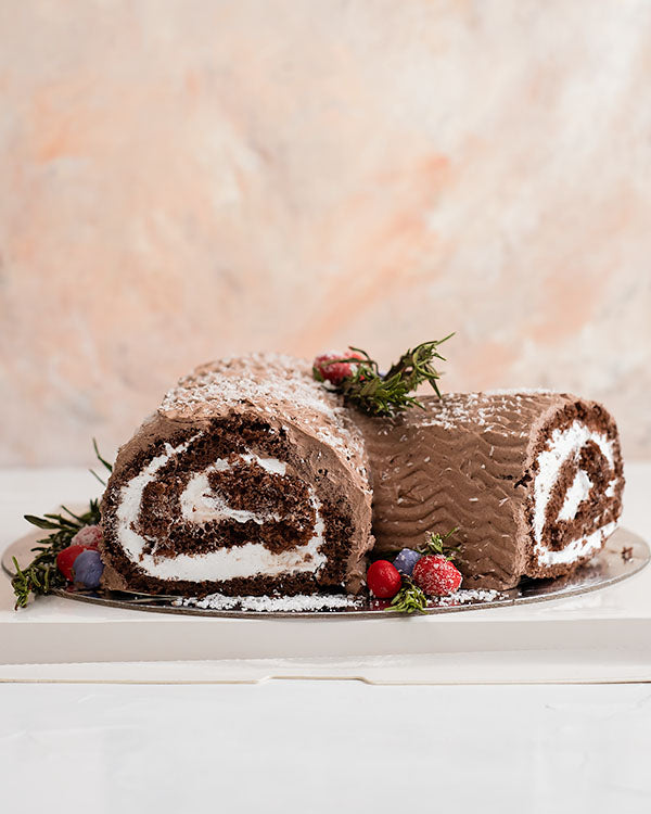 Yule log Cake by NJDChocolate & ConfectioneryYour Gift Contains: • 1kg classic chocolate cake with light creamy filling • Box Size: 20x20x30cm Handling and Storage • Keep away from direct heat and sunlight • Best stored between 12-18 °C • NOT Suitable for