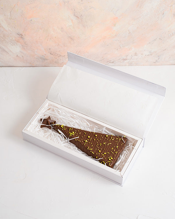 Mini Christmas treeChocolate & ConfectioneryYour Gift Contains: • Triangle shaped chocolate bar with multiple layer filling • Flavor: Pistachio, Roasted Nuts and Biscoff • Weight of Chocolate: 300grams • Box Size: 29x12x4cm Handling and Storage • Keep awa