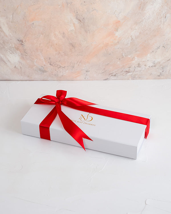 Mini Christmas treeChocolate & ConfectioneryYour Gift Contains: • Triangle shaped chocolate bar with multiple layer filling • Flavor: Pistachio, Roasted Nuts and Biscoff • Weight of Chocolate: 300grams • Box Size: 29x12x4cm Handling and Storage • Keep awa