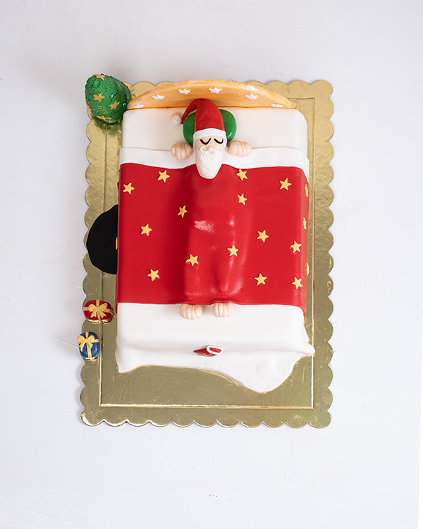 Sleeping Santa Cake by NJDChocolate & ConfectioneryYour Gift Contains: • 2kg Vanilla/Chocolate Sponge Cake • Filling: Vanilla cream/Milk Chocolate Ganache Handling and Storage • Keep away from direct heat and sunlight • Best stored between 12-18 °C • Suit