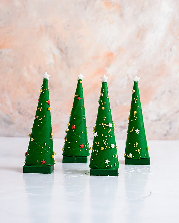 4 Edible Christmas Trees by NJDChocolate & ConfectioneryYour Gift Contains: • 4 mini chocolate cones with rich Pistachio praline fillings and nuts • Weight of Chocolate: 350grams • Box Size: 18x18x14cm Handling and Storage • Keep away from direct heat and