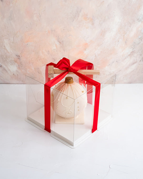 Edible Bauble by NJDChocolate & ConfectioneryYour Gift Contains: • Smash ball with 8 chunky Christmas theme assorted chocolates • Flavors: Pistachio, Sepculoos, Hazelnut, Praline, Peanut Butter • Hammer: 1 • Size of Chocolate: 12x12x14cm • Box Size: 20x20