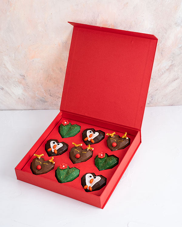 9pcs Assorted Christmas Collection by NJDChocolate & ConfectioneryYour Gift Contains: • 9 assorted Christmas theme chocolates • Flavor: Pistachio, Hazelnut and Roche • Chocolate Milk, Dark and White • Weight of Chocolate: 500grams • Box Size: 24x24x4cm Ha