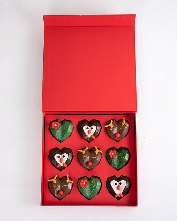9pcs Assorted Christmas Collection by NJDChocolate & ConfectioneryYour Gift Contains: • 9 assorted Christmas theme chocolates • Flavor: Pistachio, Hazelnut and Roche • Chocolate Milk, Dark and White • Weight of Chocolate: 500grams • Box Size: 24x24x4cm Ha