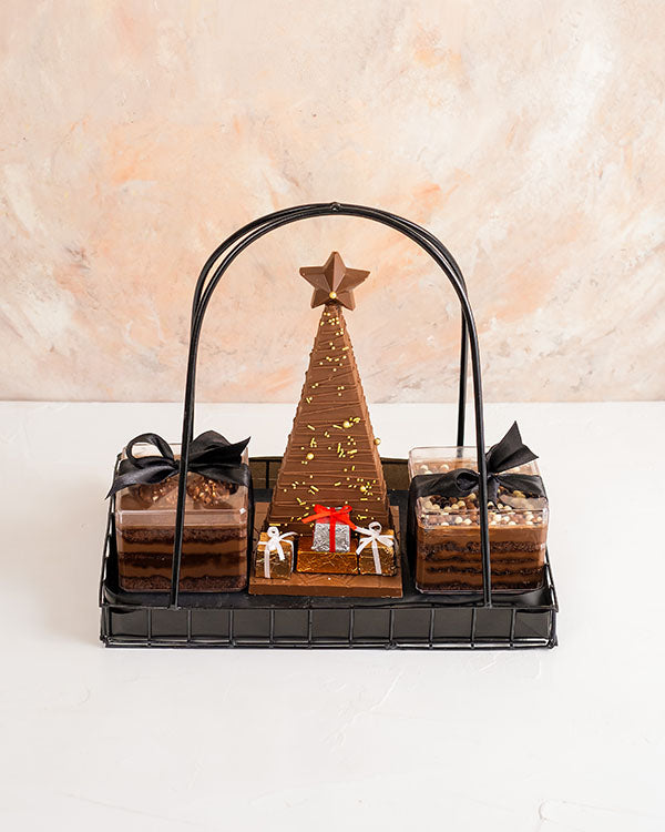 Jar Cakes and Chocolate Tree HamperChocolate & ConfectioneryYour Gift Contains: • Christmas tree chocolate bar with Pistachio and Biscoff filling: approx. 400grams • 2 Jar cake in Ferrer and Chocolate Ganache flavors • Weight of Jar cake: 250grams each •