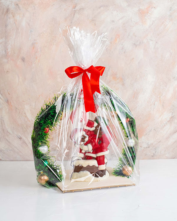 Truffles and 3D Santa by NJDChocolate & ConfectioneryYour Gift Contains: • 10 assorted Milk chocolate truffles decorates as baubles on the wreath • Flavors: Peanut Butter, Hazelnut, Pistachio Praline and Roche • Edible Santa - 500grams approx. • Tray Size
