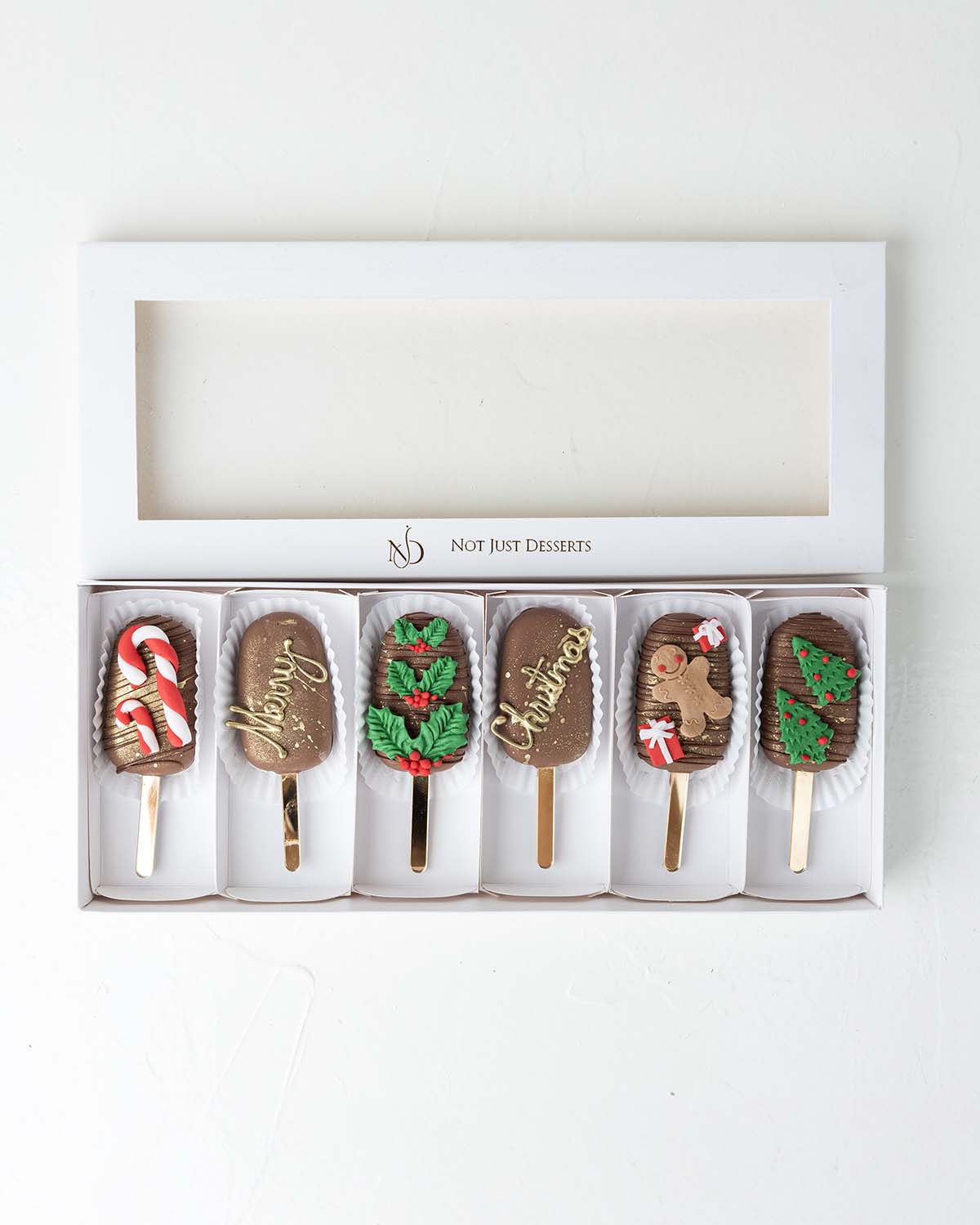 Christmas '24 CakesiclesChocolate & ConfectioneryYour Gift Contains:• 6 Christmas theme cake Cakesicles• Flavor: Chocolate/Vanilla/Red Velvet• Cakesicles Weight: 400g• Box Size: 35×14.5x4cmHandling and Storage• Keep away from direct heat and sunlight• Bes