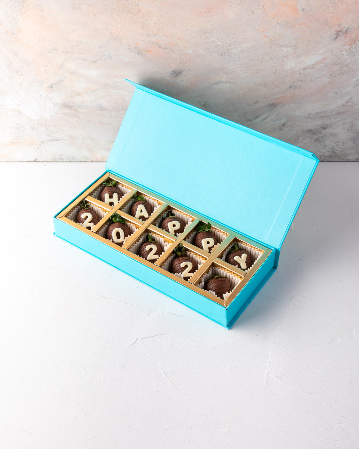 Happy 2022 Chocolate Strawberries by NJDChocolate & ConfectioneryYour Gift Contains: • 10 pieces Milk chocolate covered strawberries with "Happy 2022" message Box Size: LxBxH: 25x12x4cm HANDLING AND STORAGE Keep away from direct heat and sunlight Best sto