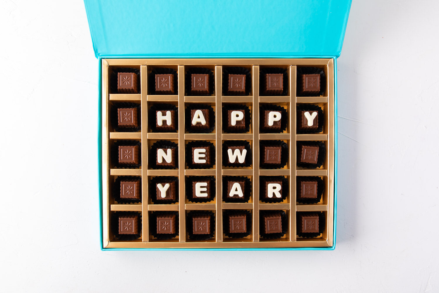 Customizable New Year Chocolates by NJDChocolate & ConfectioneryYour Gift Contains: • 30 pieces assorted Milk chocolate Flavors: Pistachio Praline, Rice Crispy, Rocher, Sepculoos, Hazelnut Praline • Personalized text up to 18 characters (6 in each row) Bo