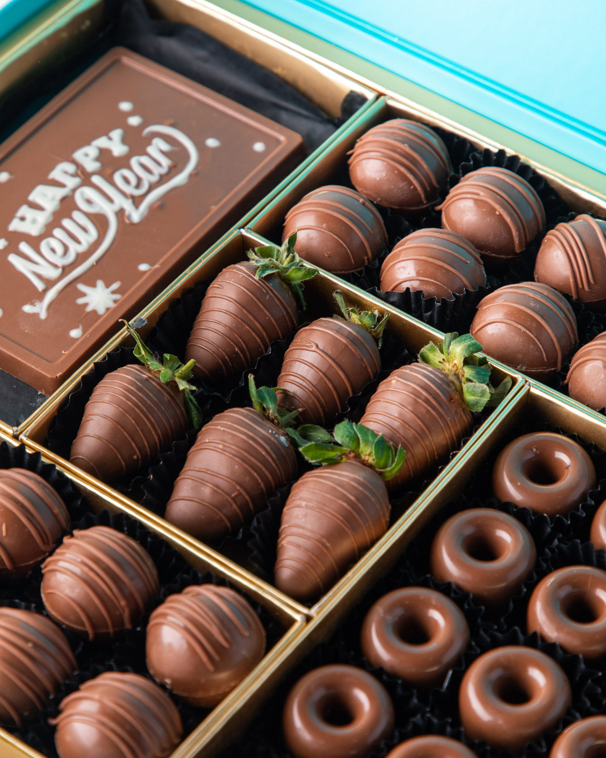 Chocolates and Strawberries New Year Greetings by NJDChocolate & ConfectioneryYour Gift Contains: • 24 pieces Milk Chocolate Truffles in Peanut butter, Rice Crispy, Pistachio, Sepculoos and Hazelnut Gandoua and Pistachio Praline flavors • 50gms Milk Choco