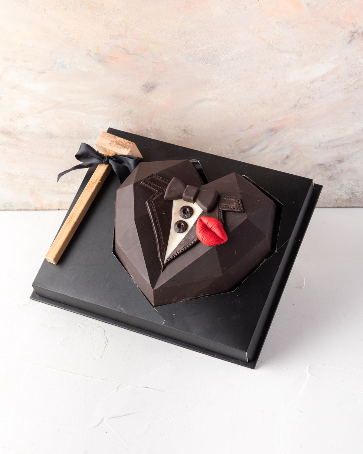 A Gift for Him by NJDChocolate & ConfectioneryYour Gift Contains: • Piñata heart styled as Tuxedo • Made with dark and milk chocolate • 10 pieces assorted milk and dark chocolate truffles (flavors: nuts, praline, and ganache) Box Size: LxBxH: 21x25x9.5cm