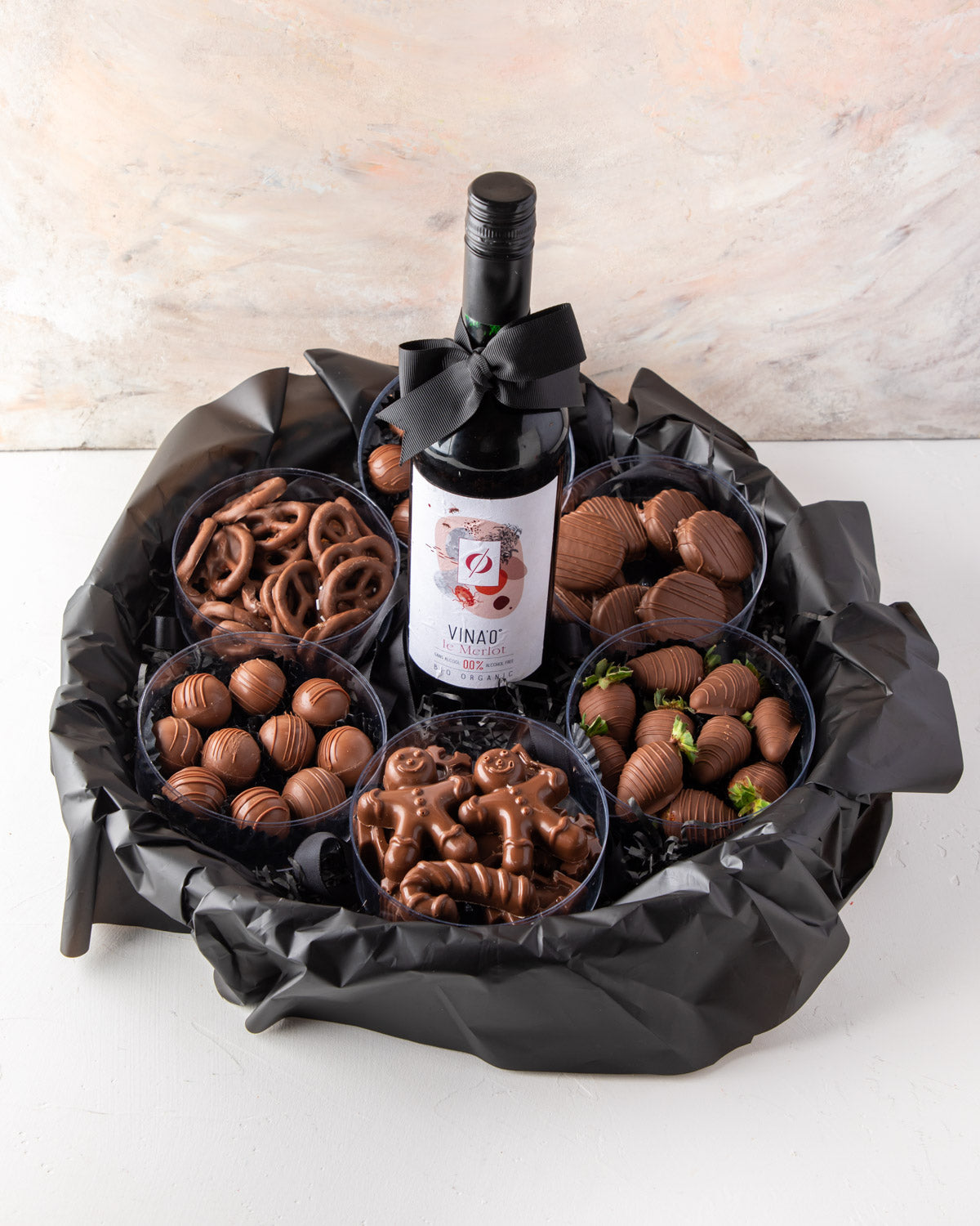 Assorted Hamper with Non Alcoholic Wine by NJDChocolate & ConfectioneryYour Gift Contains: • VINA’0° le Merlot Organic Non Alcoholic Wine, 75cl × 1 • Christmas theme shapes Milk chocolates approx. 220gms • 8pcs Milk Chocolate Covered Oreos • 10 pieces ass